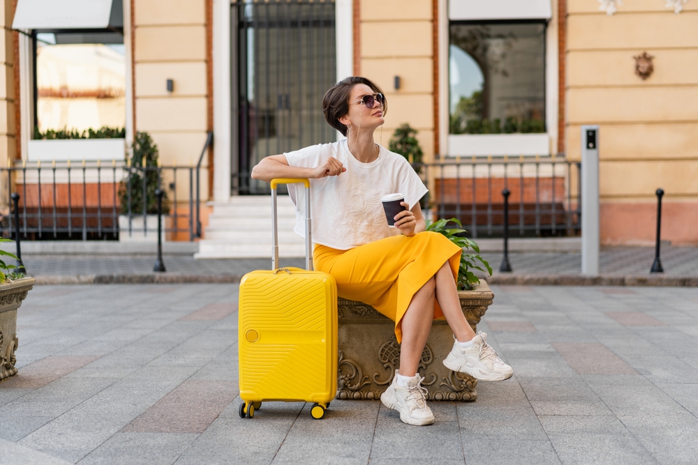 Stylish,Pretty,Woman,Traveling,With,Yellow,Suitcase,In,Europe,In
